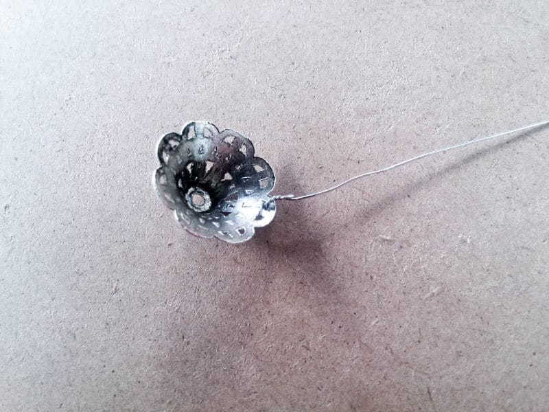 Add a piece o wire into every second hole in the space bead