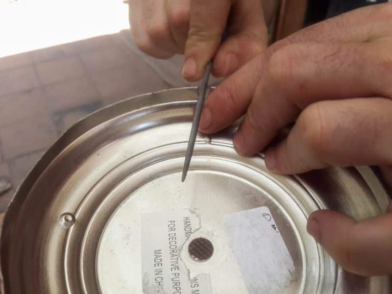 Use a metal file to smooth away any rough edges
