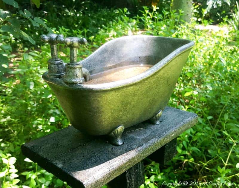 How to repurpose a bathroom accessory into a unique bird bath feature. #DIYOutdoors #BirdBathDIY #ACraftyMix #GardenFeature #Repupose