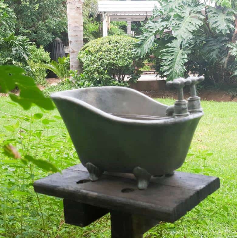 How to repurpose a bathroom accessory into a unique bird bath feature. #DIYOutdoors #BirdBathDIY #ACraftyMix #GardenFeature #Repupose