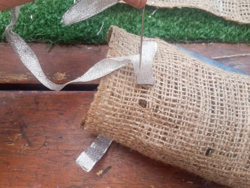 Weave a ribbon through the top of the hessian bag