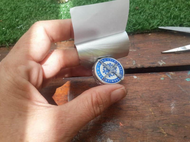 Stick the aluminium tape down over the top of the bottle top
