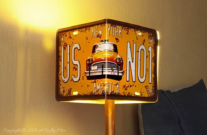 Add a little industrial chic to your decor and make this license plate lamp using pipes. Perfect for a teens room or man cave. #ACraftyMix #DIYLamp