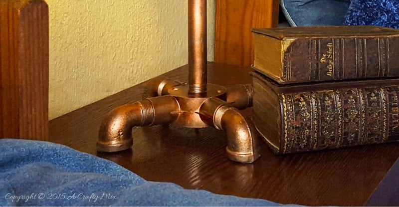 Add a little industrial chic to your decor and make this license plate lamp using pipes. Perfect for a teens room or man cave. #ACraftyMix #DIYLamp