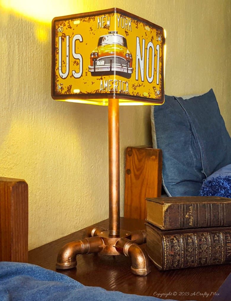 Add a little industrial chic to your decor and make this license plate lamp using pipes. Perfect for a teens room or man cave. #ACraftyMix #DIYLamp
