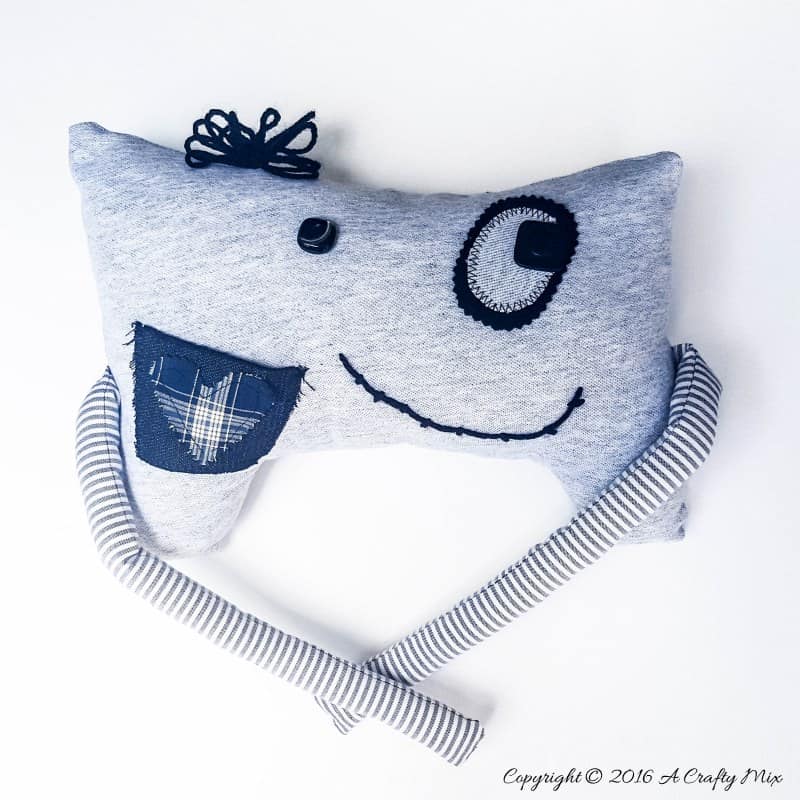 Make your own little Momster. Includes a free easy-to-sew pattern and lots of ideas to customize their little faces. #sewing #momster #ACraftyMix #freepattern