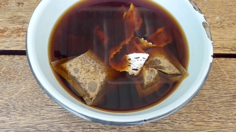 Soak the lace and ribbons in coffee or tea to stain and instantly age them