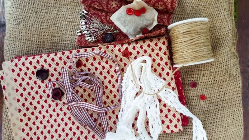 Fabric scraps, lace, burlap, buttons, and safety pins