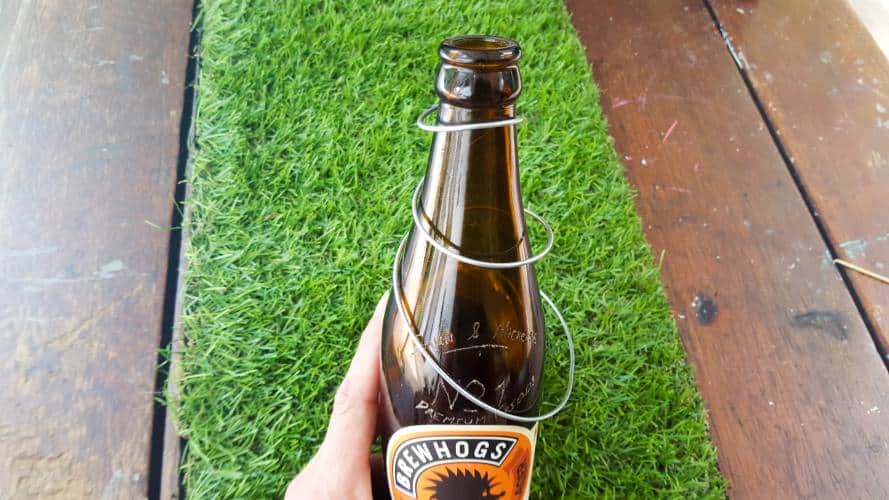 Wind the wire around the bottle starting at the top and working your way down