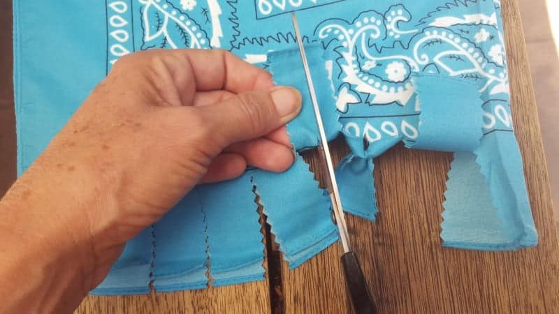 Cut a small slit through both pieces of the stips