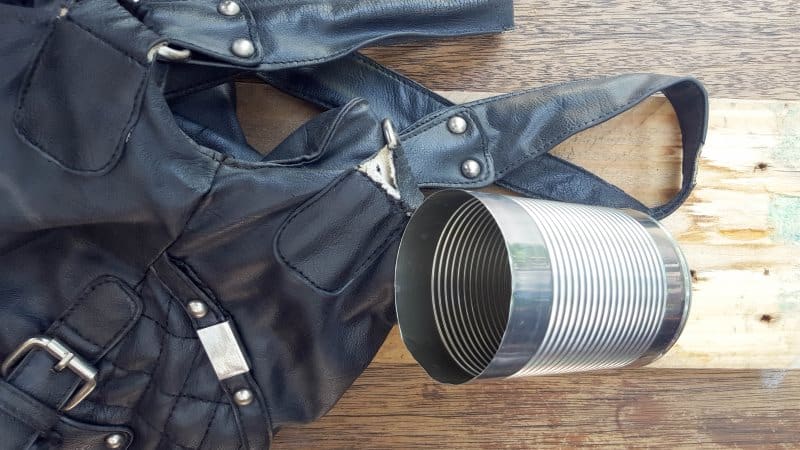 A broken handbag and tin cans
