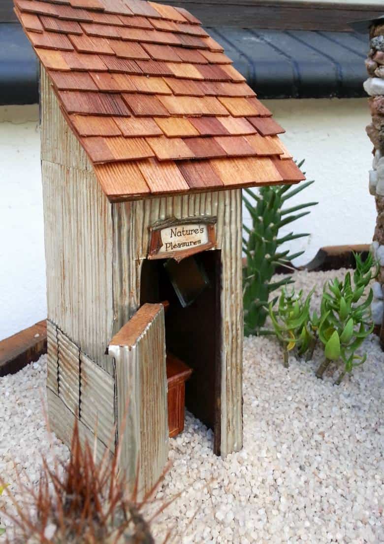 How to make a desert fairy garden and log cabin using a wooden tissue box. #DesertFairyGarden #FairyLogCabin #ACraftyMix #TissueBoxRepurpose