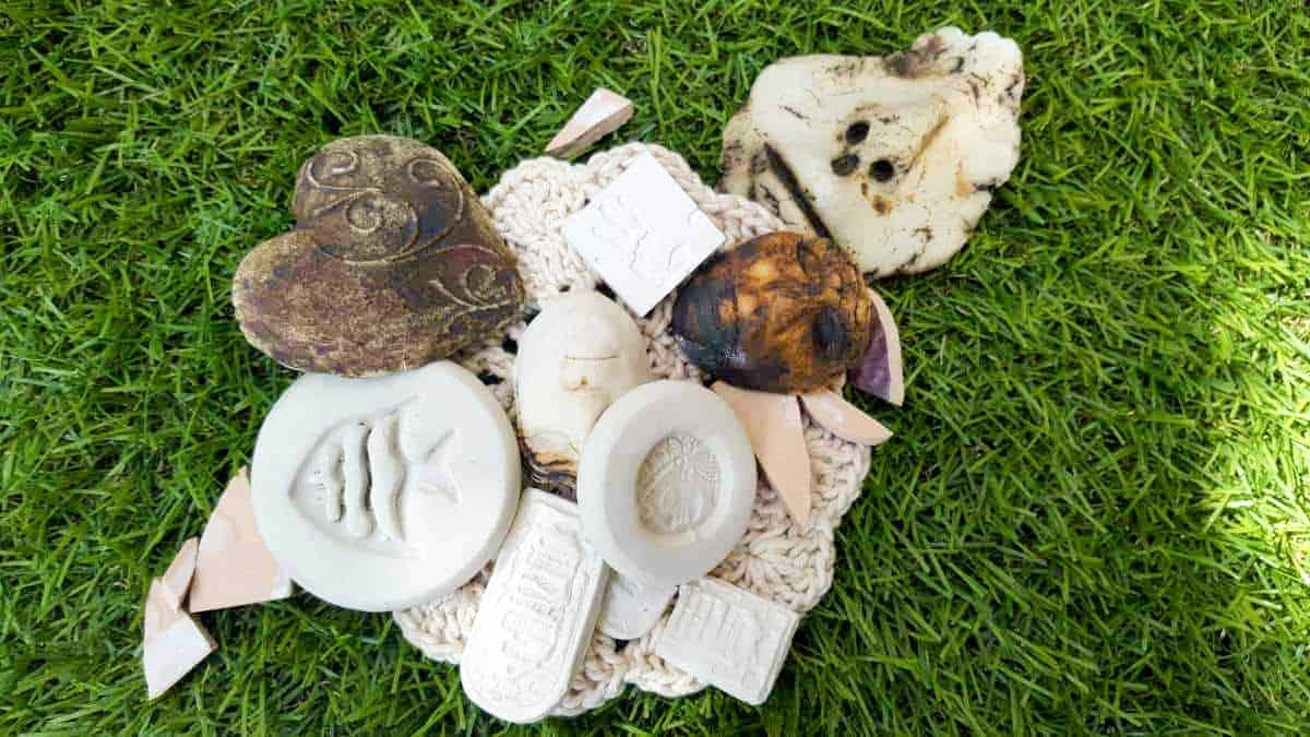 A collection of broken pottery pieces and unfinished art work