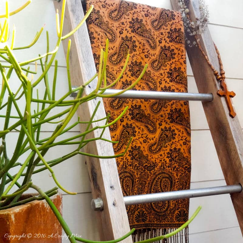 A throw and a little plant make a lovely statement on this easy to make industrial chic display ladder.