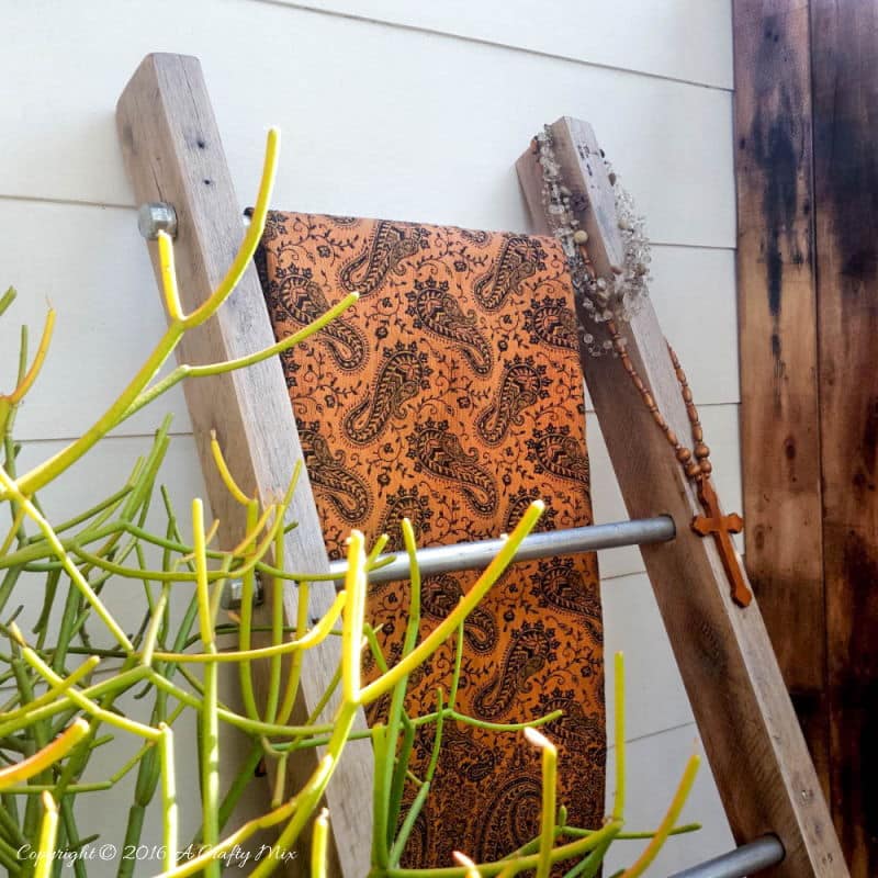 A throw and a little plant make a lovely statement on this easy to make industrial chic display ladder. 