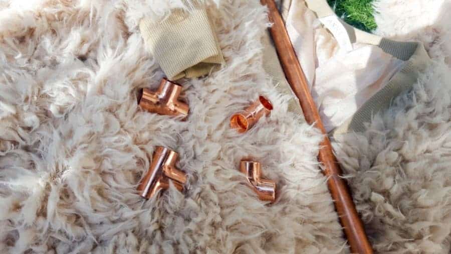 Repurpose an old sweater and copper pipes into a DIY bed for your purr babies. It's quick and easy to do, and a great way to recycle an those old sweaters! Your kitties will love it. #DIYCatBed #DIYPets #DIYHome #PetFriendly