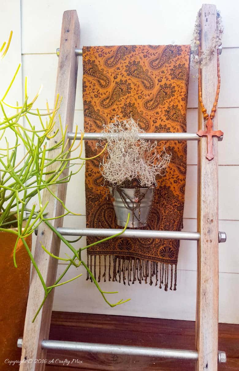 A throw and a little plant make a lovely statement on this easy to make industrial chic display ladder.