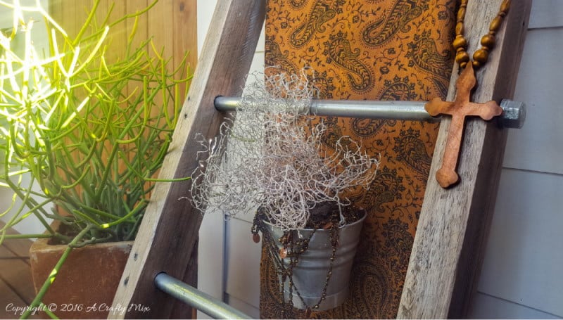 A throw and a little plant make a lovely statement on this easy to make industrial chic display ladder.