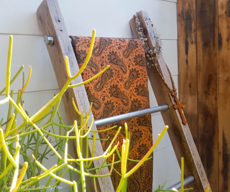 A throw and a little plant make a lovely statement on this easy to make industrial chic display ladder.