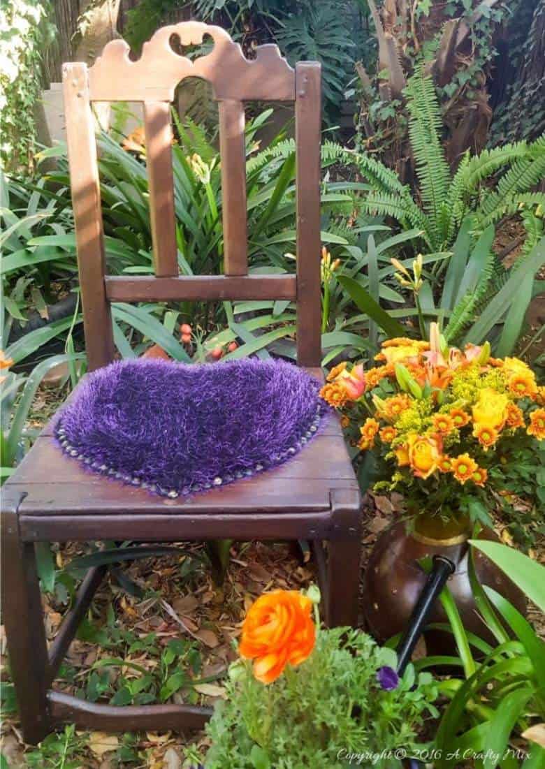 Celebrating nature and a well loved chair in true gypsy style. Bold beautiful colors and tactile fabrics mixed with well worn wood. What more do you need to add some boho magic to your decor? #gypsyDecor #chairrepurpose #ACraftyMix #heartcushion #bohodecor
