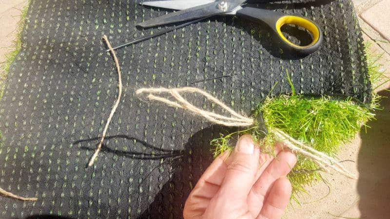 Thread the twine through the holes. #DIYDoormat #CustomDoorMat #ACRaftyMix #OutdoorDoorMat #AstroTurfDoormat #DoormatTutorial