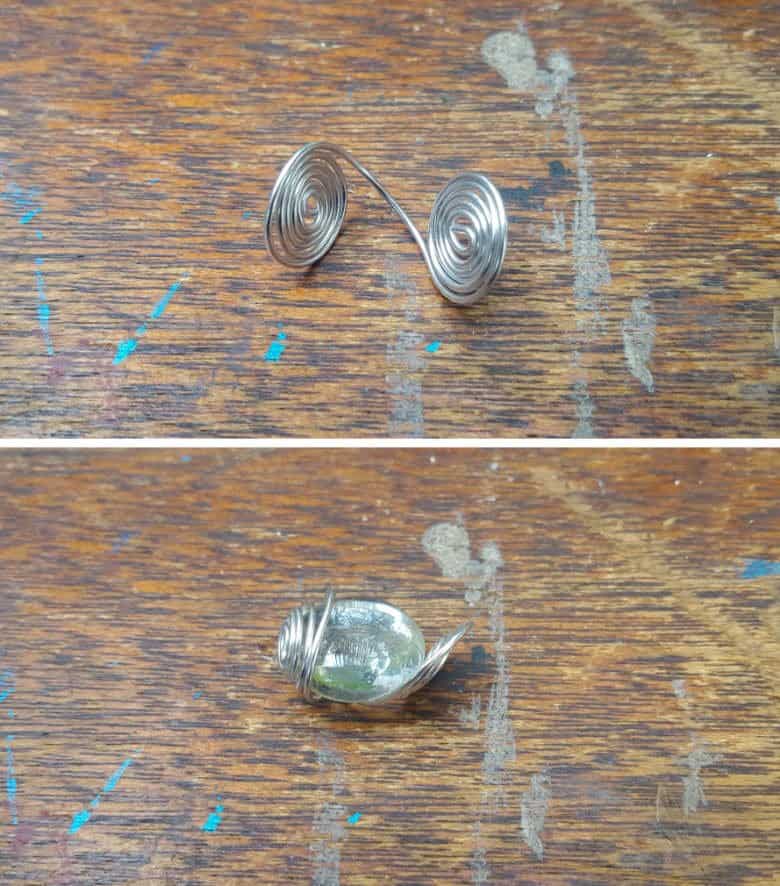 Bend the two ends of the curled wire upwards and place the glass bead inside and wrap the edges up to enclose the glass bead.