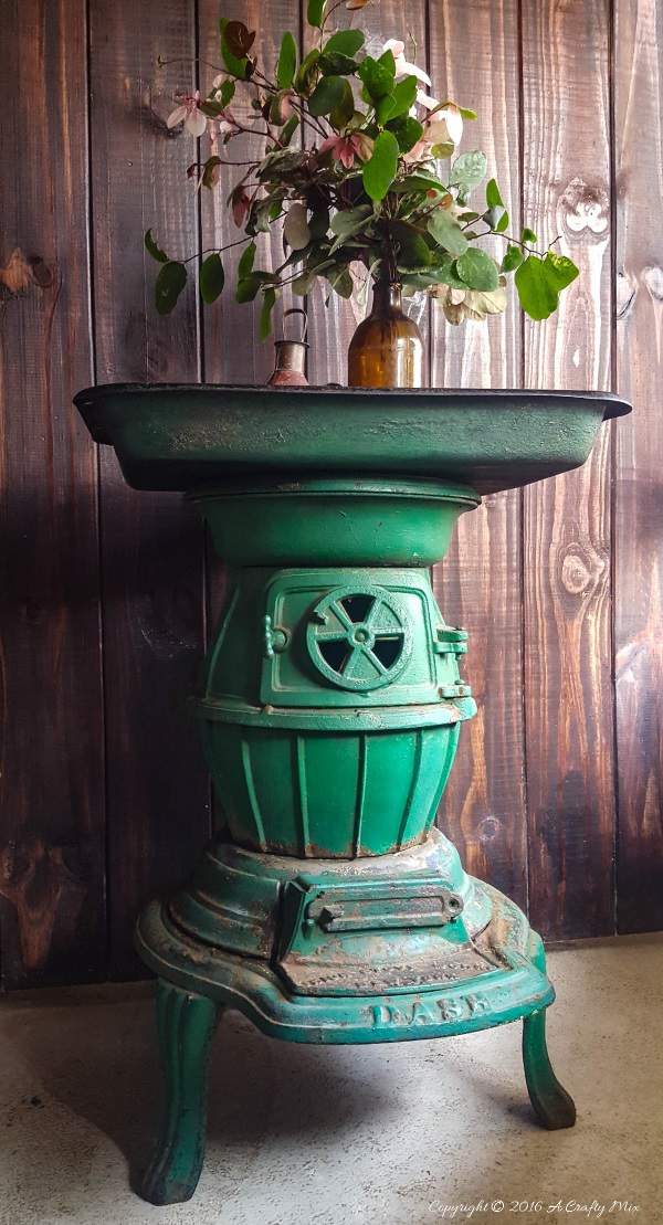 A cast iron stove and an old roasting pan make an interesting OOAK side table. Full tutorial on the blog