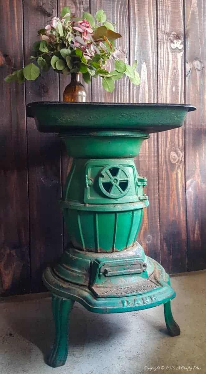 Repurpose a cast iron stove and an old roasting pan to make an interesting OOAK side table. Come see how we did it on the blog #Repurpose #Castironstove #ACraftyMix #recycledhomedecor #homedecor