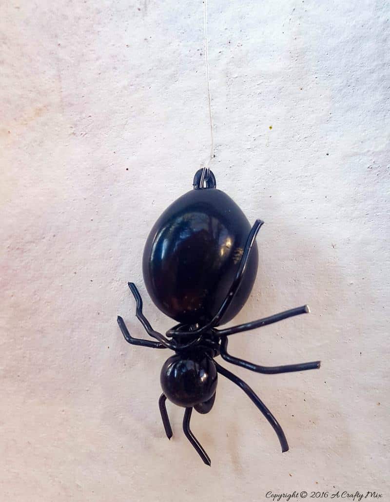 Suspend the spider using fishing line