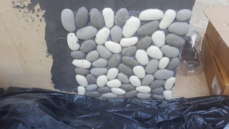 Paste the pebbles tiles into the grout adhesive