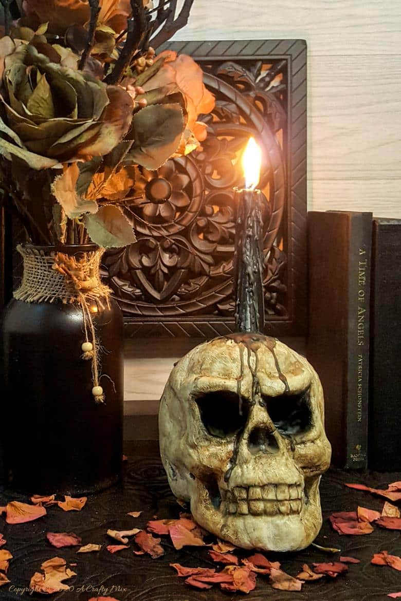 This easy to follow tutorial will show you how to age a Styrofoam or polystyrene skull and give it a spooktacular skull makeover. Can be used as a Halloween display or as a candle holder. #ACraftyMix