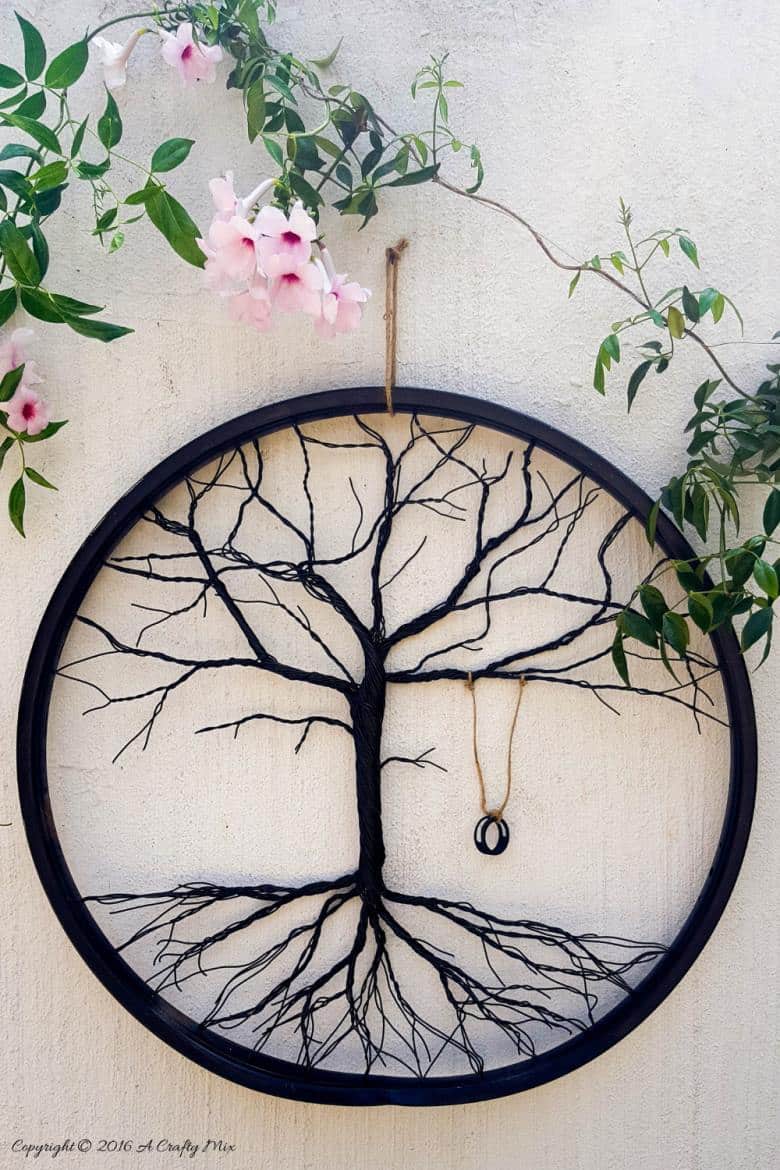 Have you ever considered repurposing a bent bicycle wheel into beautiful garden decor? This beginner-friendly tutorial will should you how easy it is to turn that wheel into a tree of life. #wireworks #ACraftyMix #GardenDecor