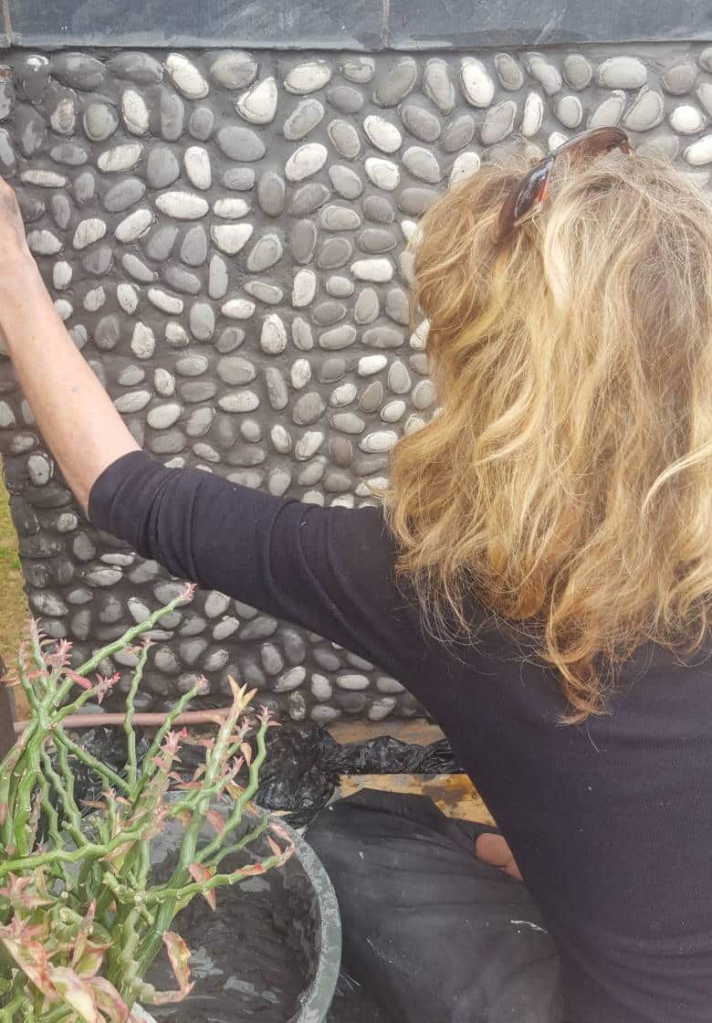 Fill the gaps between the pebbles with grout