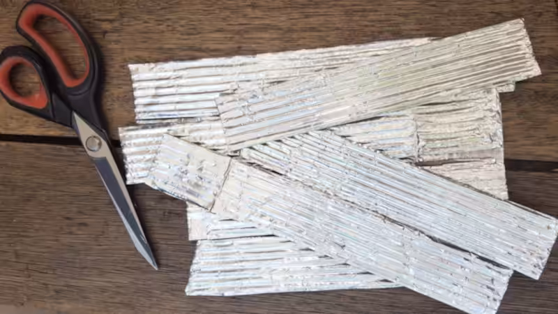Strip of corrugated cardboard covered in aluminium foil tape