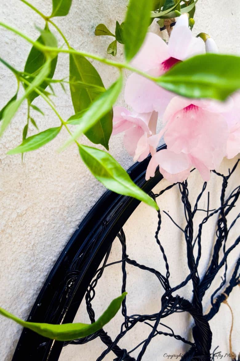 Have you ever considered repurposing a bent bicycle wheel into beautiful garden decor? This beginner-friendly tutorial will should you how easy it is to turn that wheel into a tree of life. #wireworks #ACraftyMix #GardenDecor