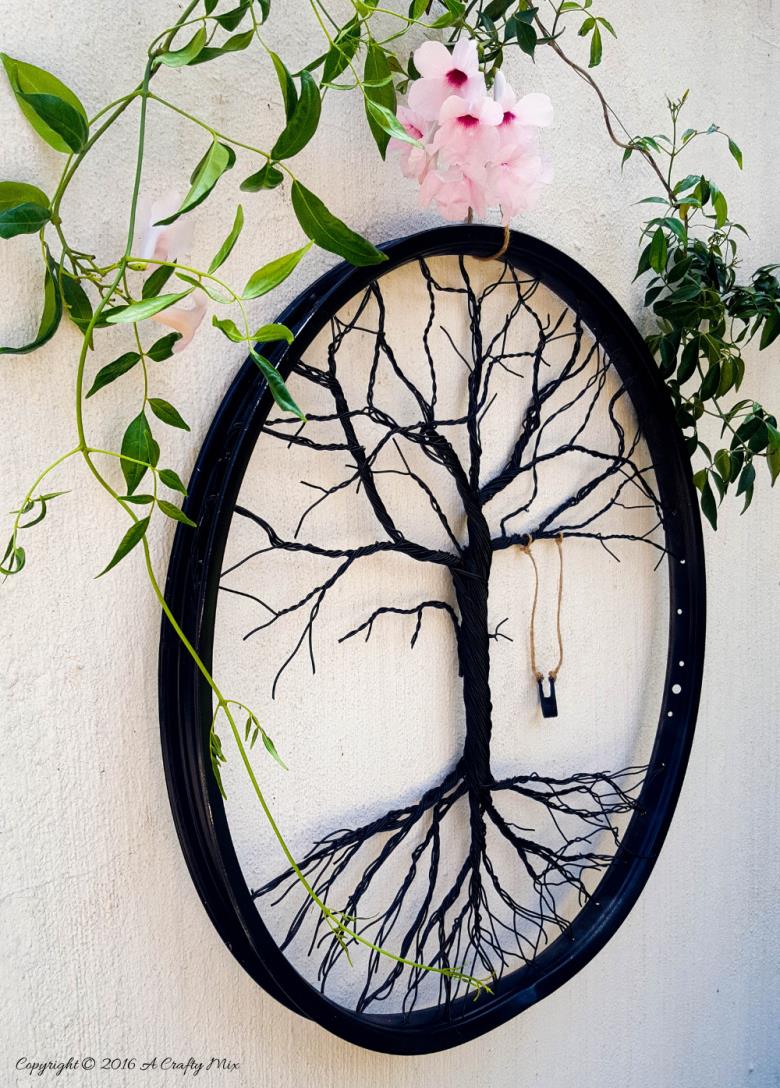 Have you ever considered repurposing a bent bicycle wheel into beautiful garden decor? This beginner-friendly tutorial will should you how easy it is to turn that wheel into a tree of life. #wireworks #ACraftyMix #GardenDecor