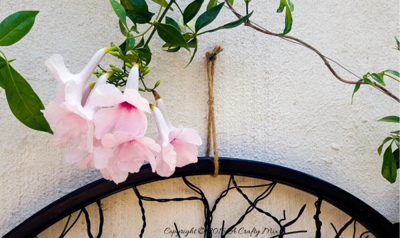 Have you ever considered repurposing a bent bicycle wheel into beautiful garden decor? This beginner-friendly tutorial will should you how easy it is to turn that wheel into a tree of life. #wireworks #ACraftyMix #GardenDecor