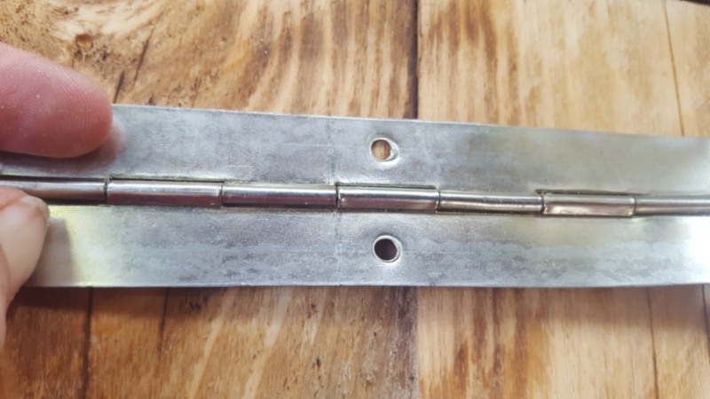 Use a piano hinge to distribute the weight evenly along the door