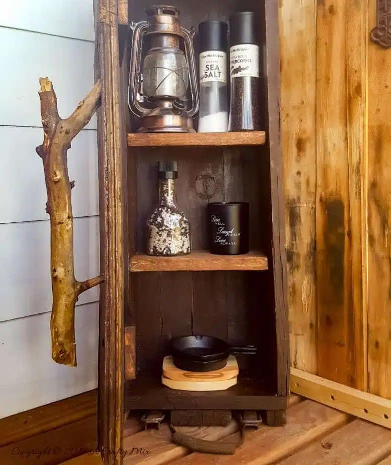 Turn a broken old ammo box into a small, sturdy kitchen cupboard. Perfect rustic home decor. This tutorial will also show you how to make a branch door handle #Repurpose #AmmoBox #ACraftyMix #RusticDecor #BranchUpcycle