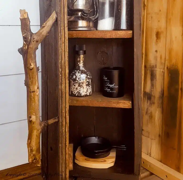 Turn a broken old ammo box into a small, sturdy kitchen cupboard. Perfect rustic home decor. This tutorial will also show you how to make a branch door handle #Repurpose #AmmoBox #ACraftyMix #RusticDecor #BranchUpcycle