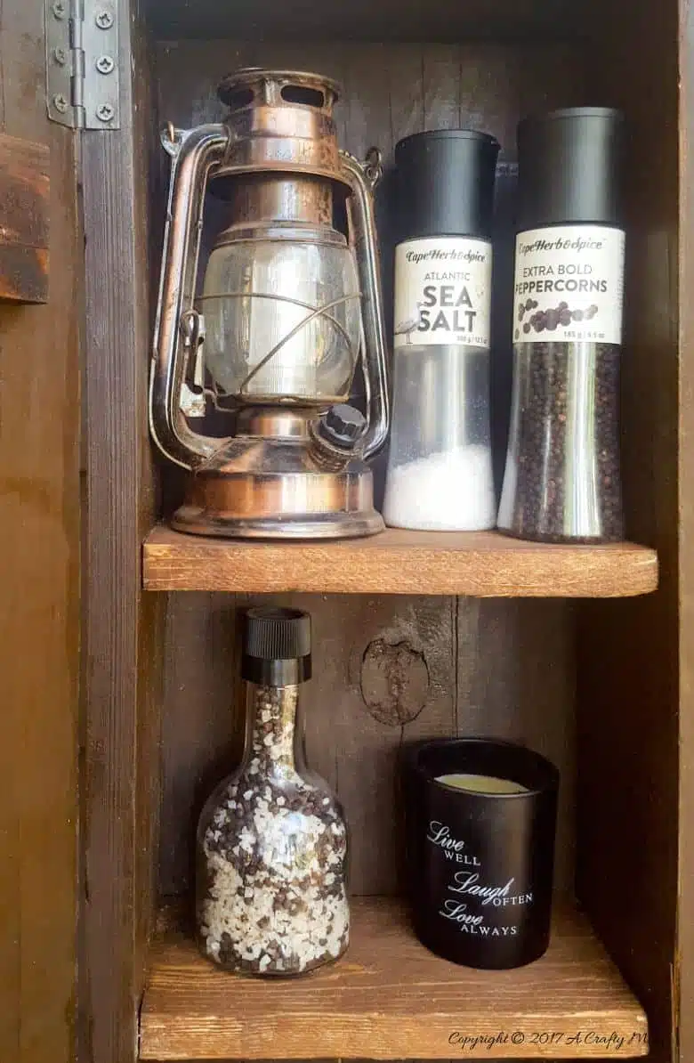 Turn a broken old ammo box into a small, sturdy kitchen cupboard. Perfect rustic home decor. This tutorial will also show you how to make a branch door handle #Repurpose #AmmoBox #ACraftyMix #RusticDecor #BranchUpcycle