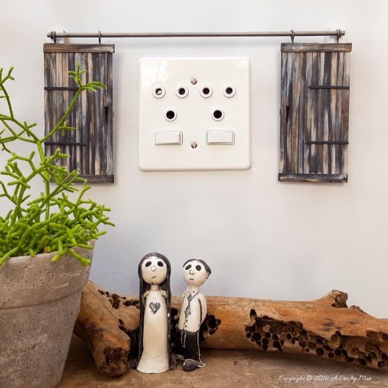 Make these adorable miniature barn doors to cover plugs. Or just hang them on the wall for a fun decor item. Quick and easy to make you can get the fill tutorial at acraftymix.com