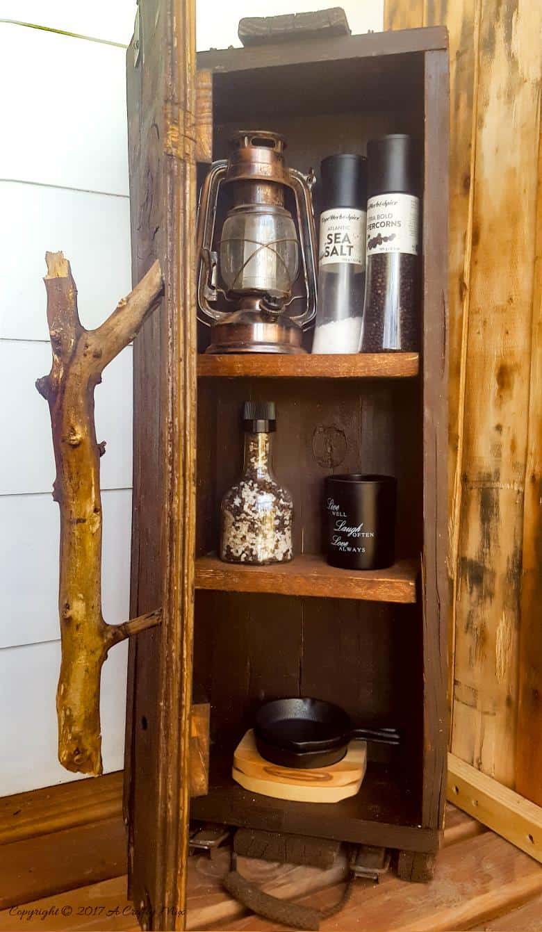 Turn a broken old ammo box into a small, sturdy kitchen cupboard. Perfect rustic home decor. This tutorial will also show you how to make a branch door handle #Repurpose #AmmoBox #ACraftyMix #RusticDecor #BranchUpcycle