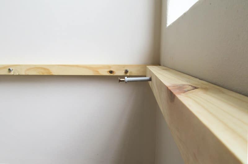 Use long wall screws to attach the supports to the walls
