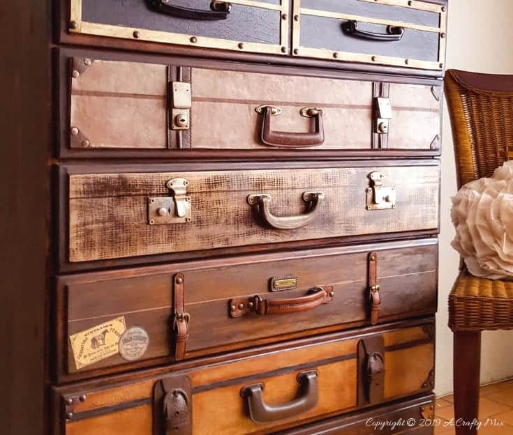 How to turn a boring chest of drawers into this classic stack of suitcases #DresserMakeover #diyhomedecor #homedecorideas #RepurposedDresser #acraftymix #RepurposedFurniture #SuitcaseDresser #chestofdrawers #DIYdresser