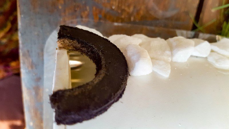 Use waterproof glue to attach the stones to the painted tin can.