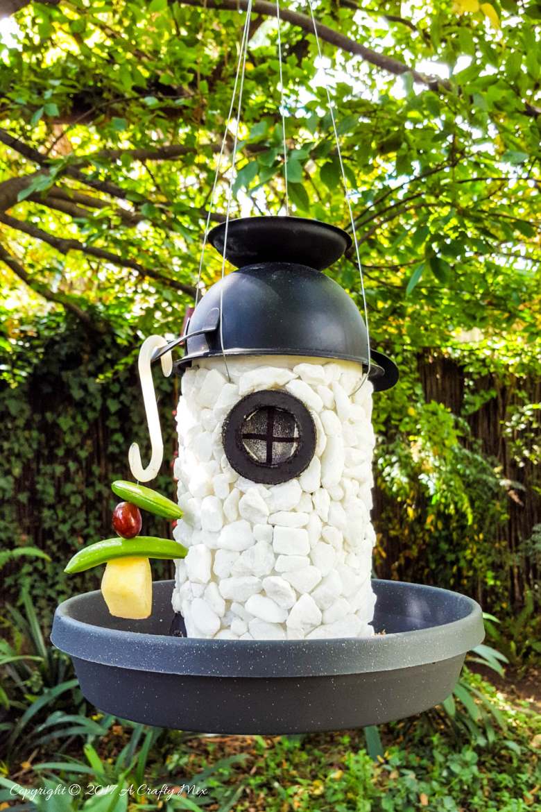 See how easy it is to turn a tin can into a fairy lighthouse bird feeder. #Birdfeeder #ACraftyMix
