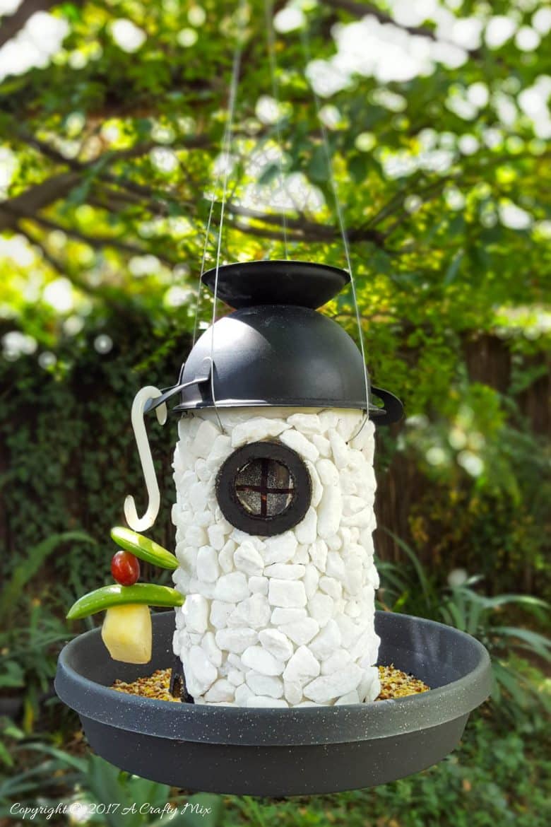See how easy it is to turn a tin can into a fairy lighthouse bird feeder. #Birdfeeder #ACraftyMix