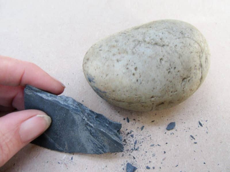 Use a pebble to chip away at the slate