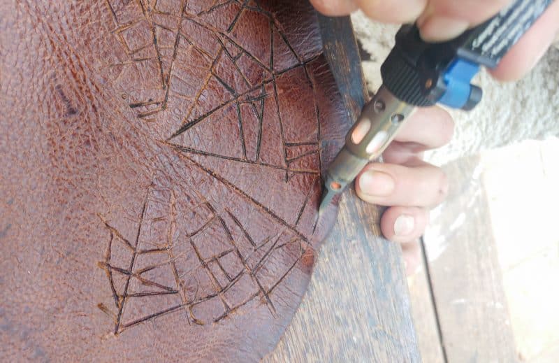 Using a soldering iron to burn the leather